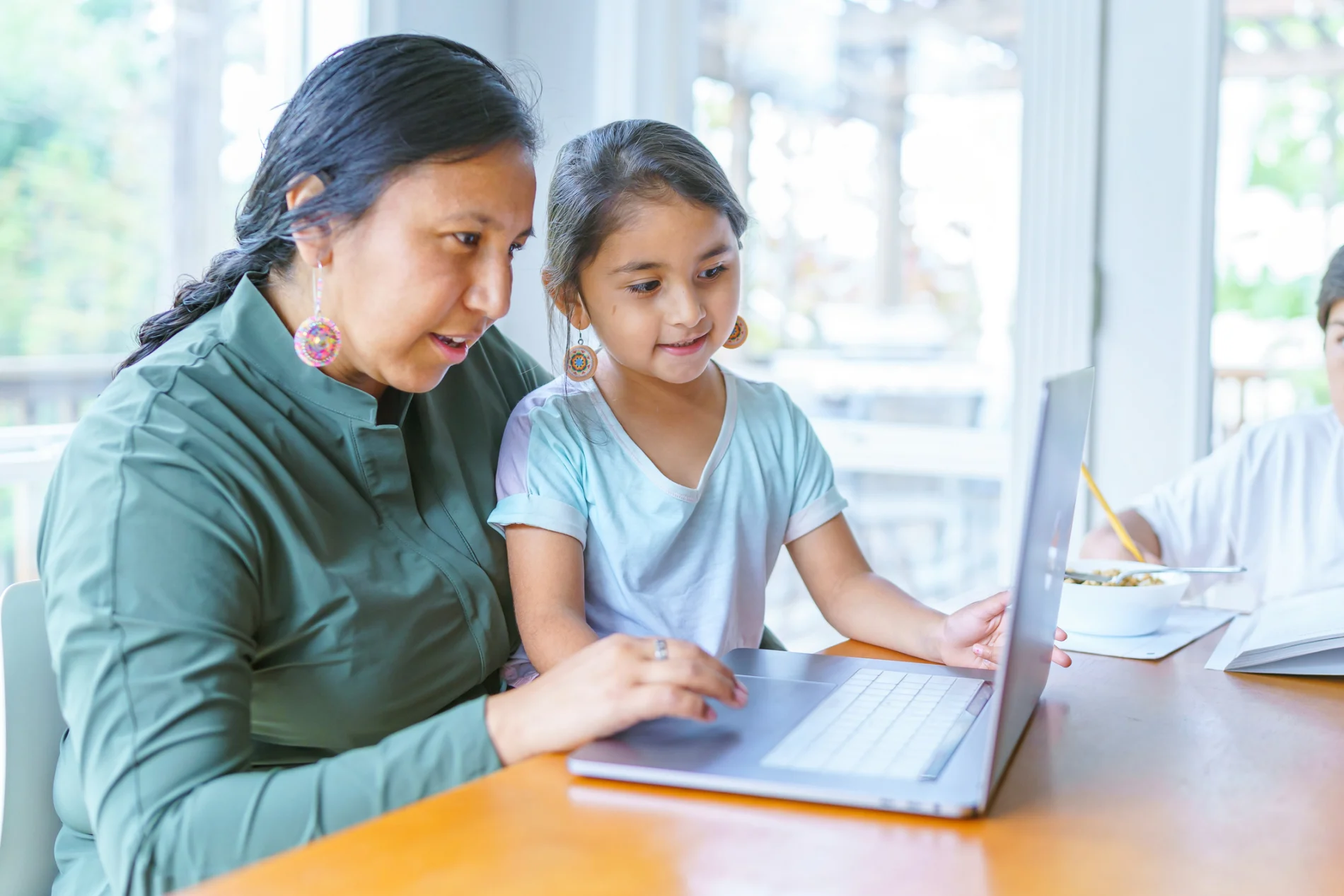 Mother and child using laptop 