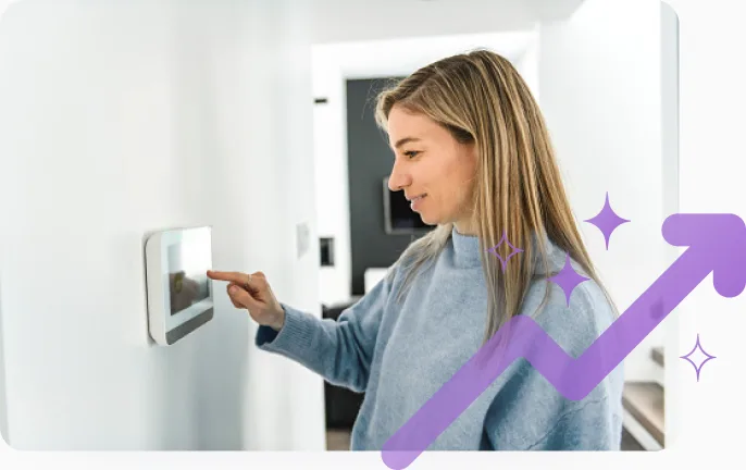 A woman adjusts a smart thermostat while participating in an energy savings event to earn TELUS Rewards. 