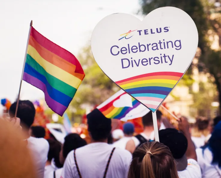 A TELUS Celebrating Diversity banner on display during a Pride parade