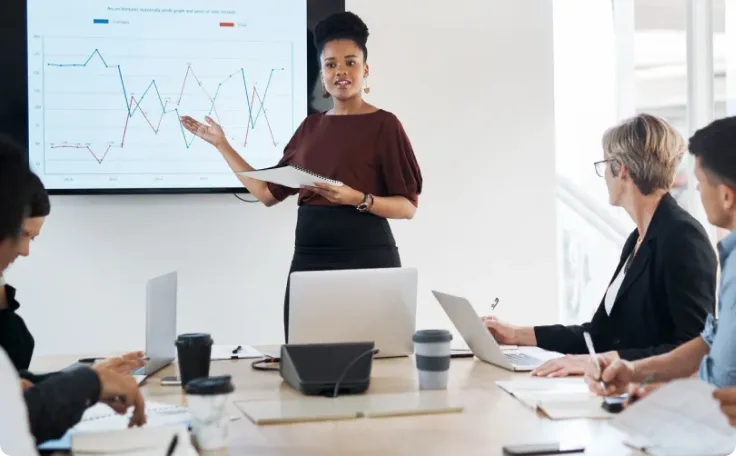 An individual giving a presentation in front of their team.