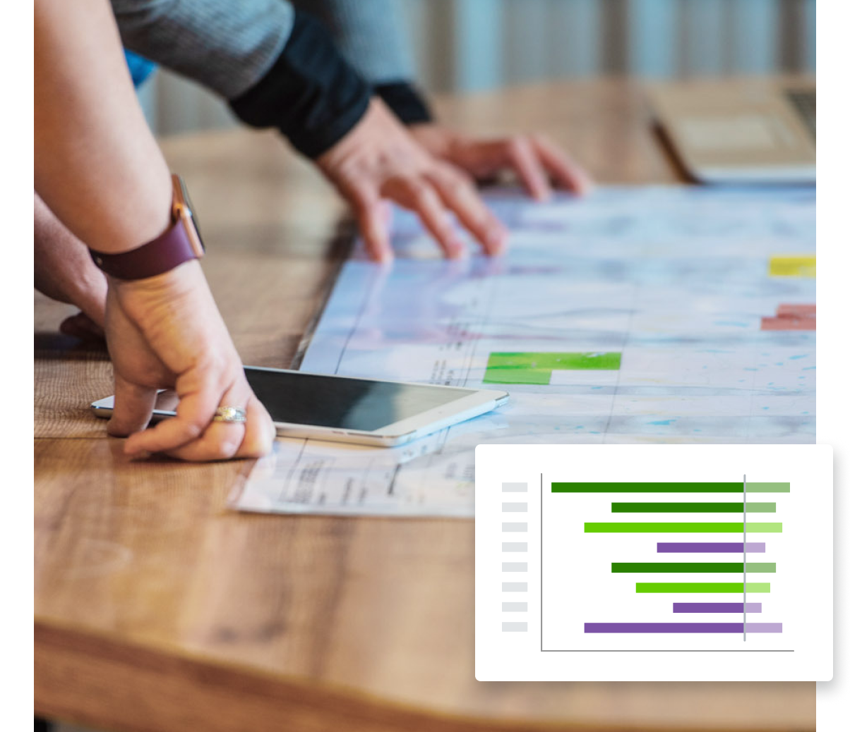 A group of people looking at a graph on a table.