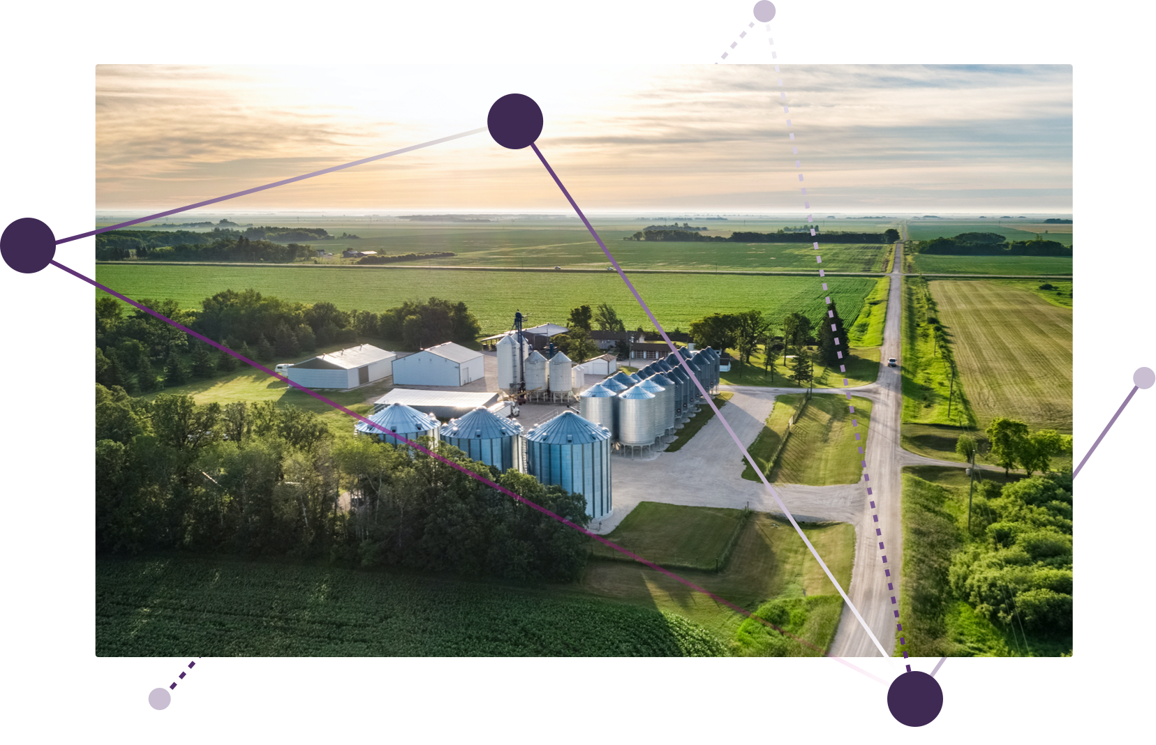 An aerial view of a farm and silos