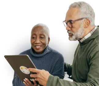 An older couple watching an Online Basics course on their tablet