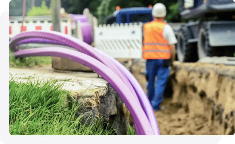 A TELUS technician installing an underground wireline.