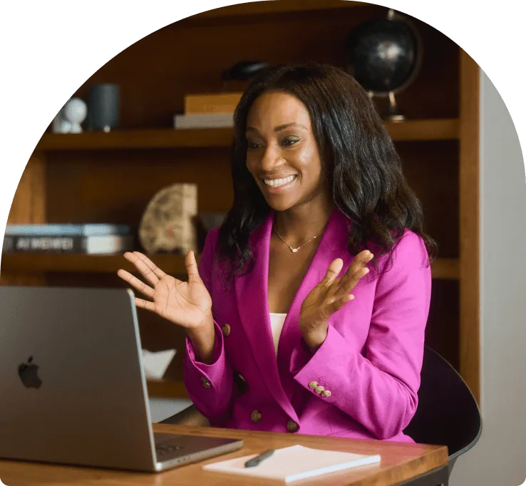 An individual seated by their desk and working on their laptop in the office.