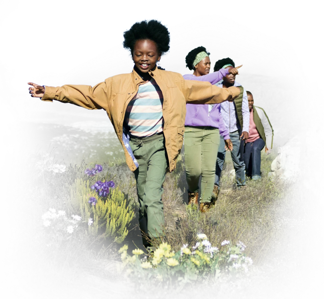 A family hiking through a meadow full of wildflowers