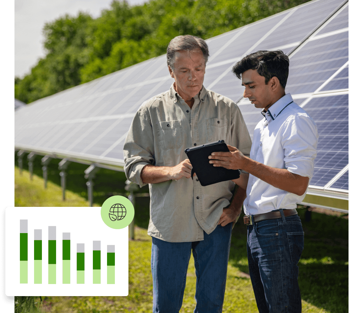 Two men with a tablet standing in front of solar panels.